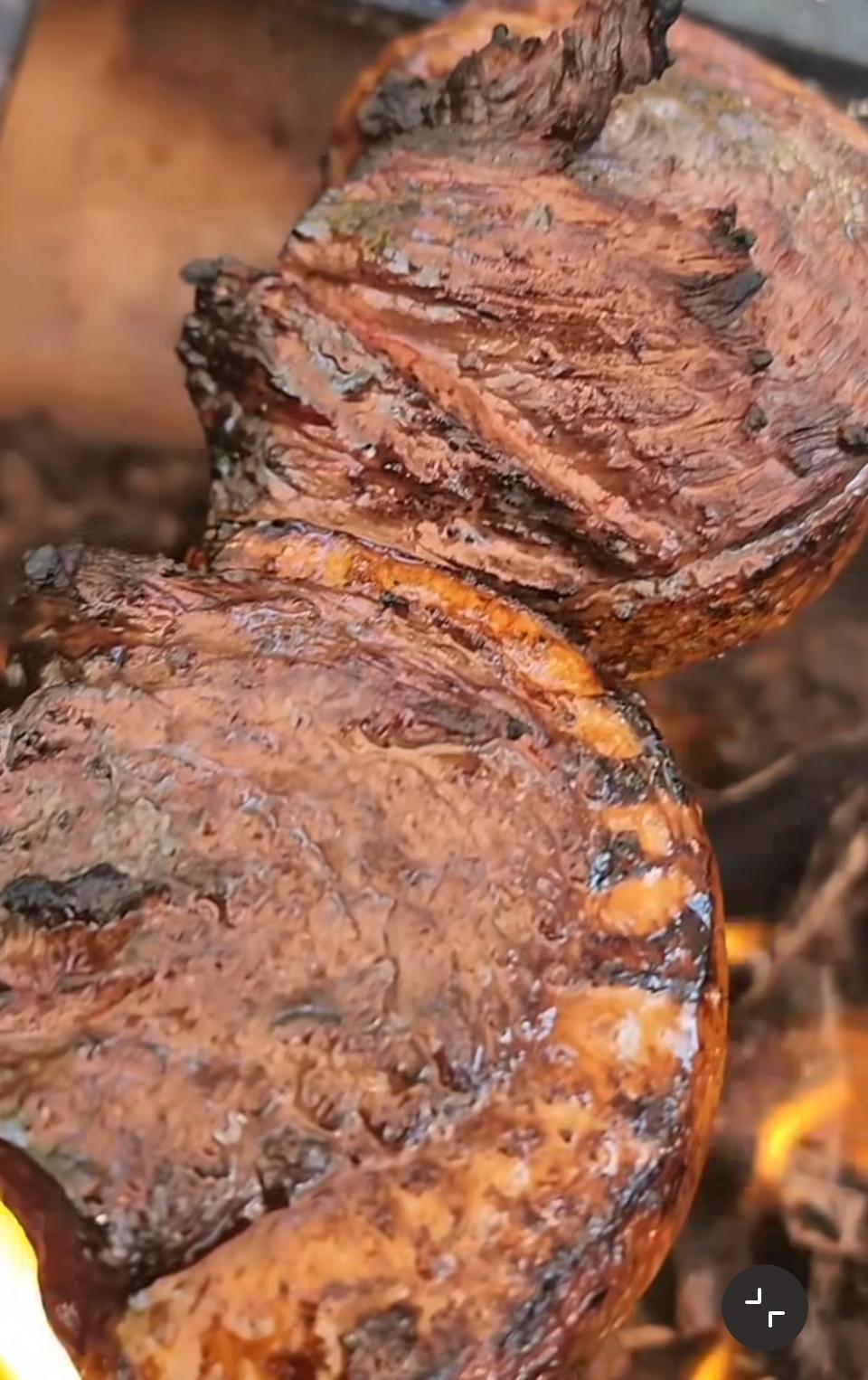 Flame-grilled meat close-up over open fire